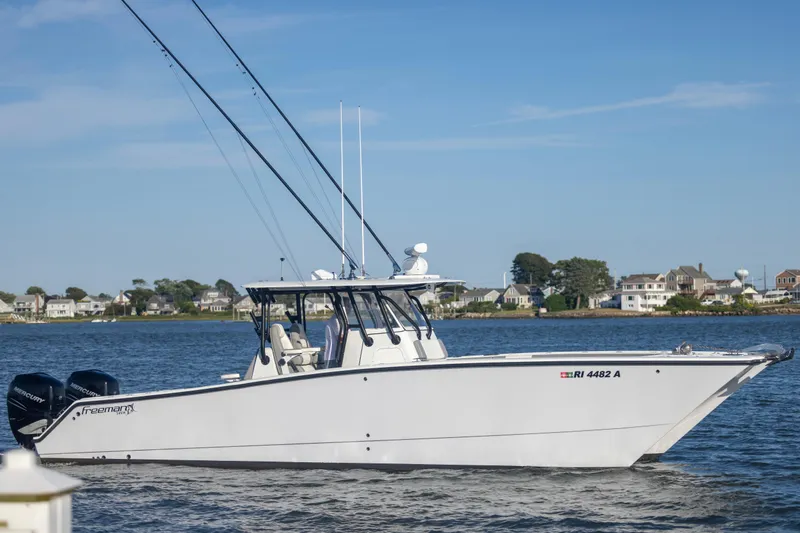  Yacht Photos Pics 2020 Freeman 34VH boat on water with coastal houses in background.