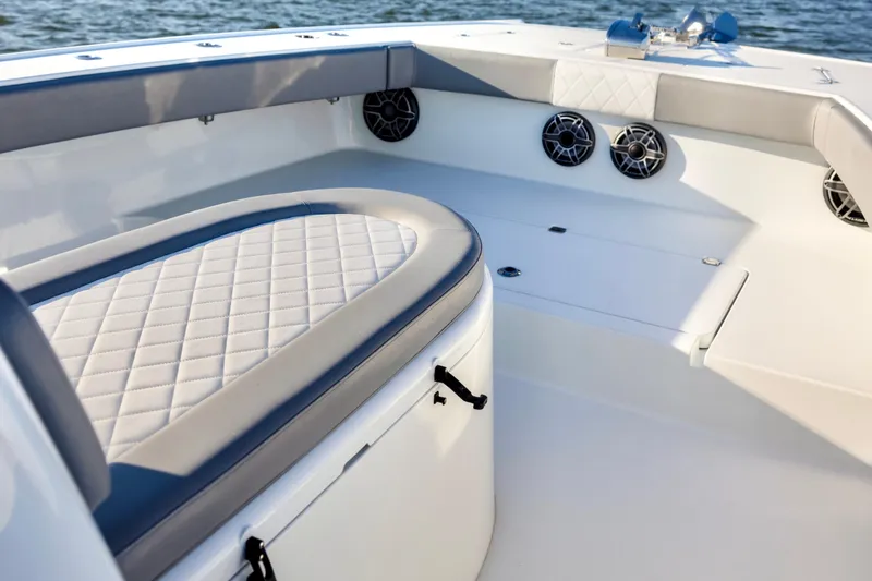  Yacht Photos Pics Luxurious seating area on a 2020 Freeman 34VH boat, featuring quilted upholstery and marine speakers.