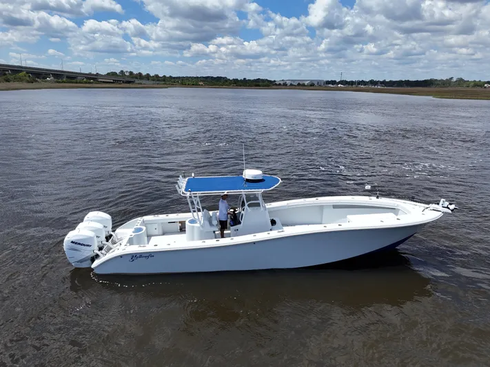  Yacht Photos Pics 2003 Yellowfin 36 Offshore boat on calm water under a partly cloudy sky.