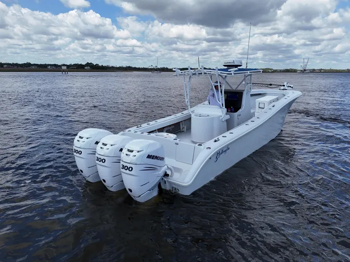  Yacht Photos Pics 2003 Yellowfin 36 Offshore boat with triple Mercury 300 engines on open water.
