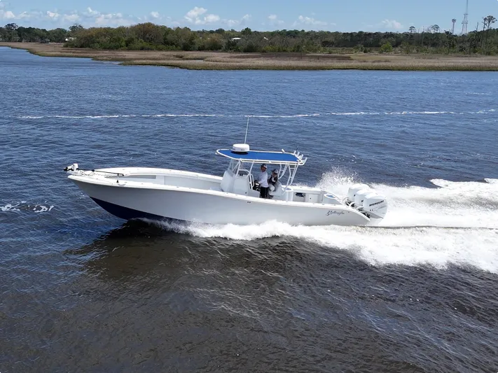  Yacht Photos Pics 2003 Yellowfin 36 Offshore boat cruising on a calm river under a clear sky.