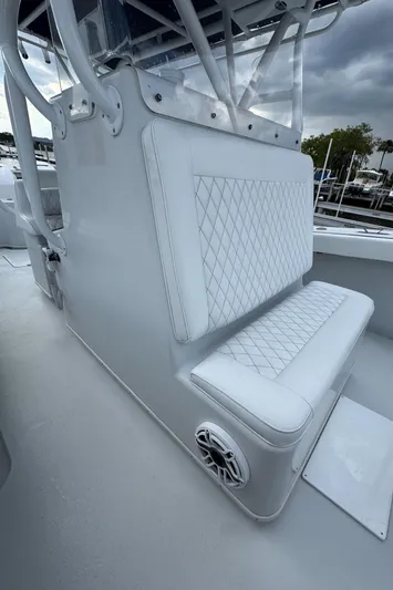  Yacht Photos Pics 2003 Yellowfin 36 Offshore boat with white cushioned seating and speaker detail.