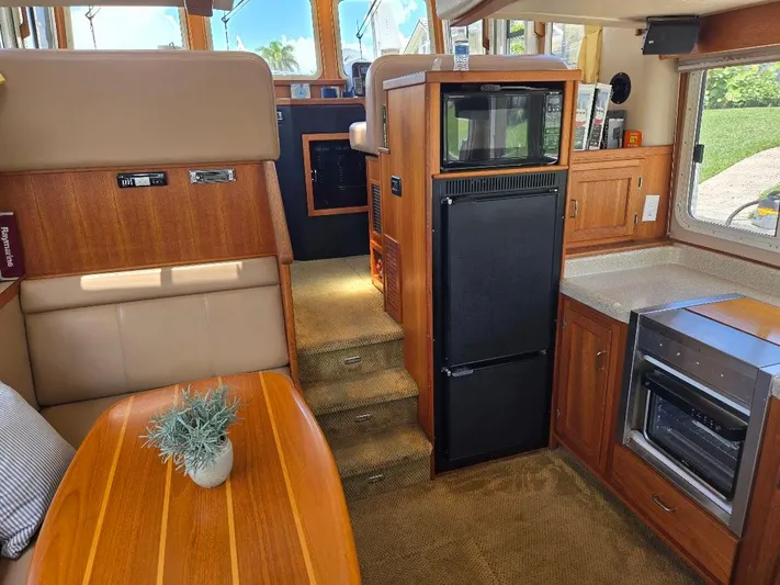 Ecola Yacht Photos Pics Interior of 2005 American Tug 34 Pilothouse with kitchen and dining area.