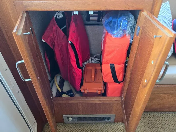 Ecola Yacht Photos Pics Storage cabinet on 2005 American Tug 34 Pilothouse with life jackets and safety gear.