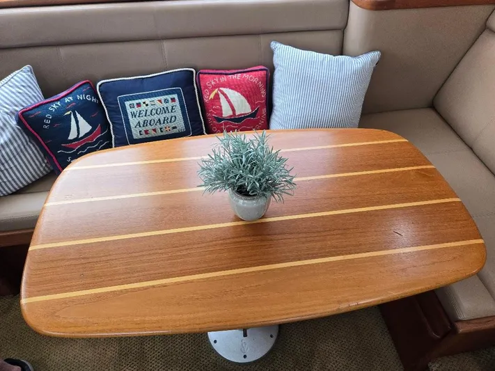 Ecola Yacht Photos Pics Cozy seating area on 2005 American Tug 34 Pilothouse with nautical-themed cushions and wooden table.