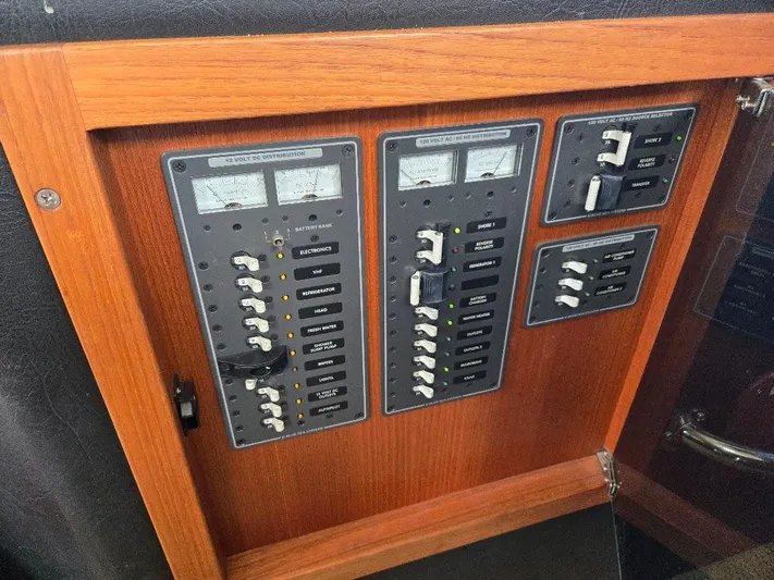 Ecola Yacht Photos Pics Electrical panel of a 2005 American Tug 34 Pilothouse boat, featuring switches and meters.
