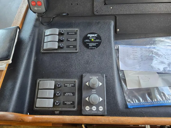 Ecola Yacht Photos Pics Control panel of a 2005 American Tug 34 Pilothouse boat with switches and documents.