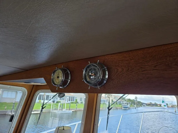 Ecola Yacht Photos Pics 2005 American Tug 34 Pilothouse interior with nautical instruments and canal view.
