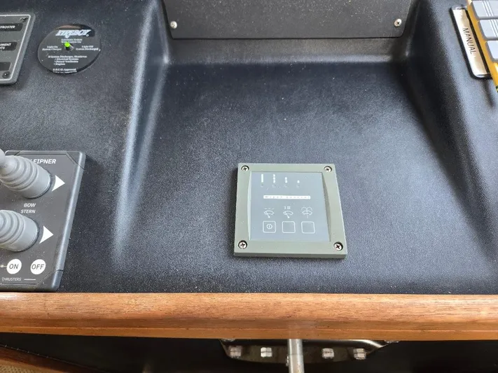 Ecola Yacht Photos Pics Control panel of a 2005 American Tug 34 Pilothouse boat, featuring joystick and display.