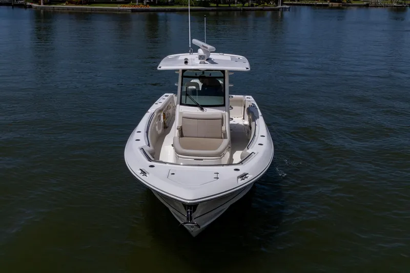 Ducky's Dinghy Yacht Photos Pics 2020 Boston Whaler 330 Outrage boat on calm water, front view.