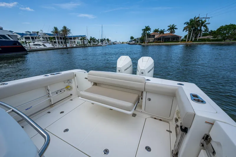Ducky's Dinghy Yacht Photos Pics 2020 Boston Whaler 330 Outrage boat with dual engines, docked in a scenic marina.