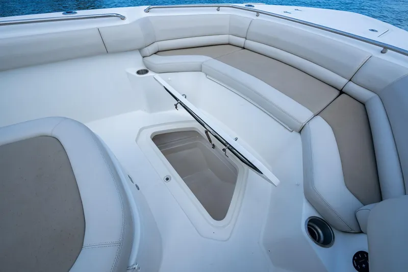 Ducky's Dinghy Yacht Photos Pics 2020 Boston Whaler 330 Outrage boat interior with cushioned seating and storage compartment.