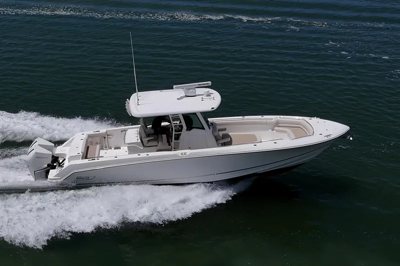 Ducky's Dinghy Yacht Photos Pics 2020 Boston Whaler 330 Outrage cruising on open water, showcasing sleek design and powerful performance.