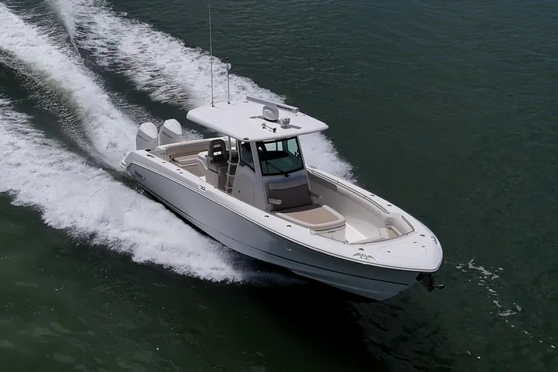 Ducky's Dinghy Yacht Photos Pics 2020 Boston Whaler 330 Outrage cruising on open water, showcasing sleek design and powerful performance.