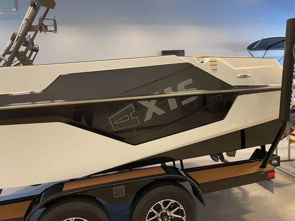 2021 Axis T23 boat on trailer, sleek design with black and white color scheme.