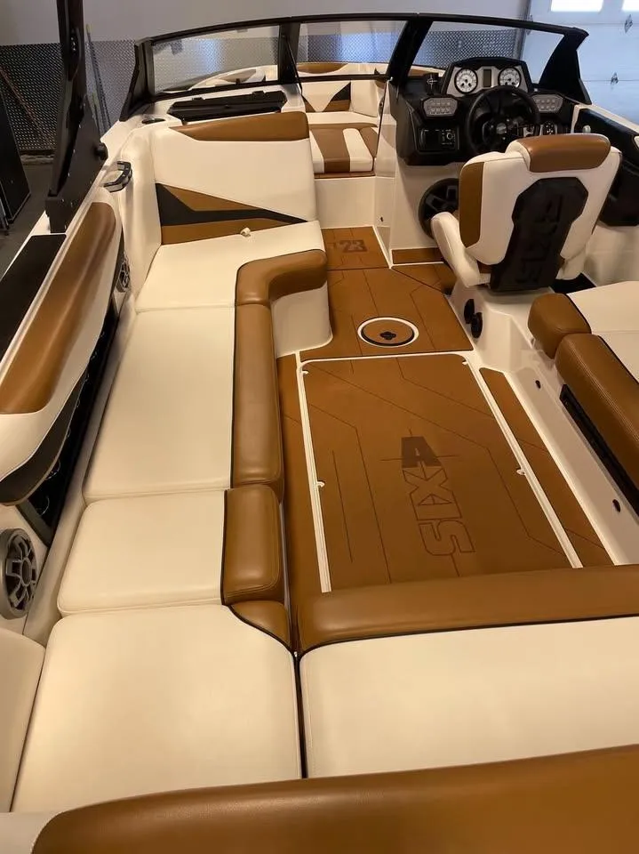 2021 Axis T23 boat interior with brown and white seating, modern dashboard, and spacious layout.