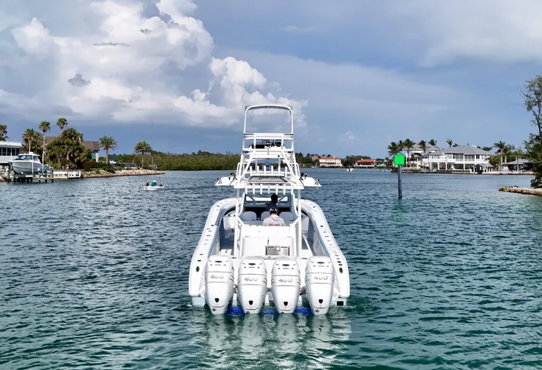  Yacht Photos Pics 2023 Yellowfin 42 boat cruising in a scenic coastal waterway.