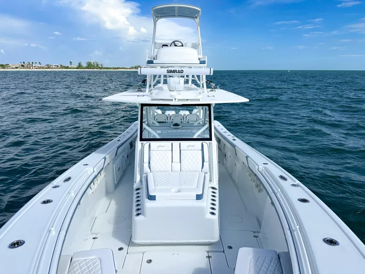  Yacht Photos Pics 2023 Yellowfin 42 boat on open water, featuring sleek design and advanced navigation equipment.