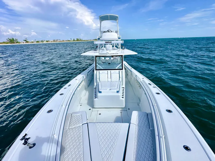  Yacht Photos Pics 2023 Yellowfin 42 boat on open water, showcasing sleek design and spacious deck.