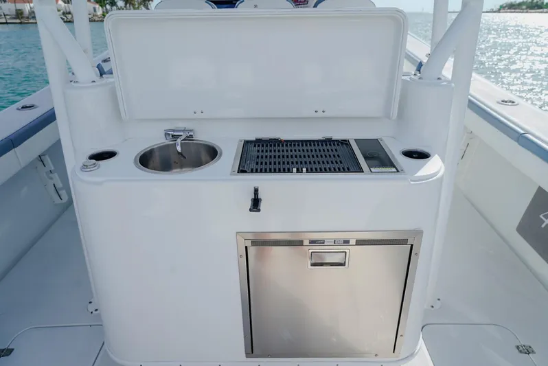  Yacht Photos Pics 2023 Yellowfin 42 boat kitchenette with sink, grill, and storage on deck.
