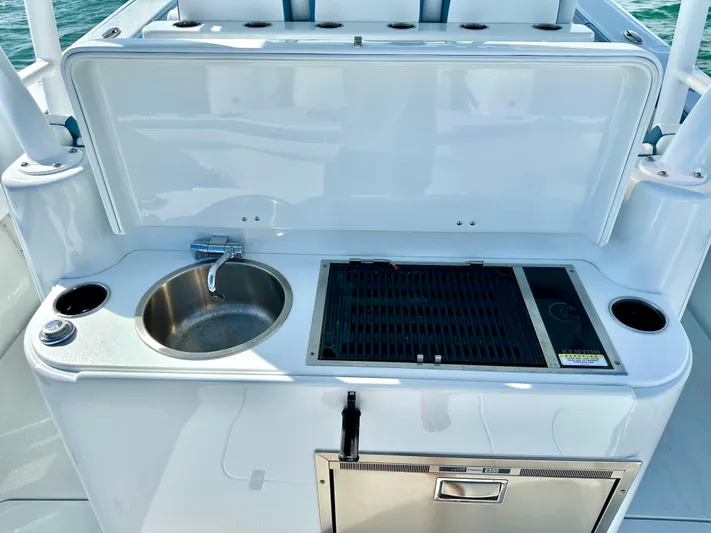  Yacht Photos Pics Outdoor kitchen on 2023 Yellowfin 42 boat with sink and grill.