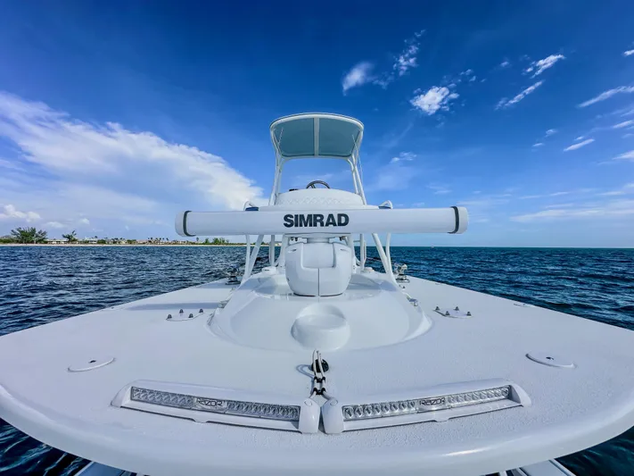  Yacht Photos Pics 2023 Yellowfin 42 boat with Simrad equipment on open water under clear blue sky.