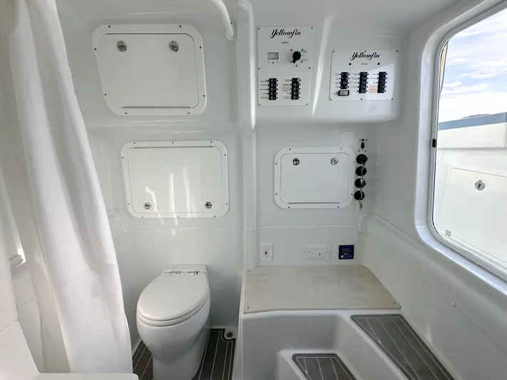  Yacht Photos Pics 2023 Yellowfin 42 boat interior with toilet, control panels, and window view.