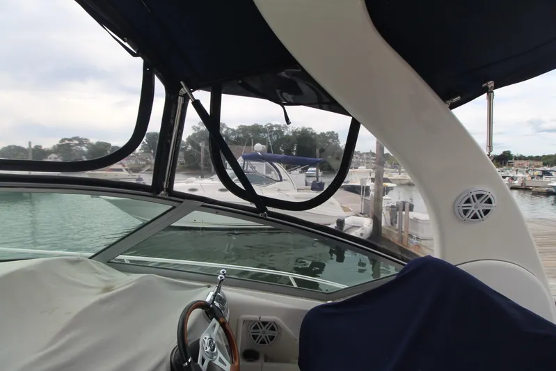  Yacht Photos Pics 2008 Sea Ray 340 Sundancer interior view at marina, showcasing helm and canopy.