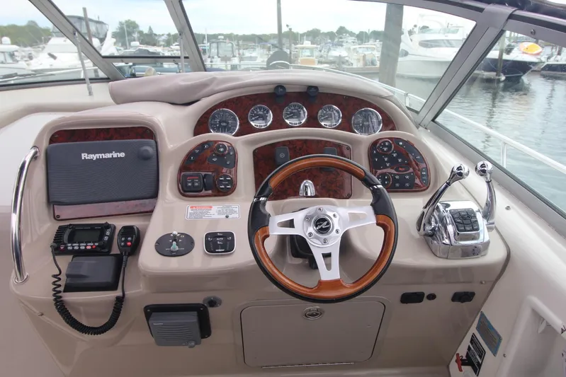  Yacht Photos Pics 2008 Sea Ray 340 Sundancer helm with Raymarine electronics and wood-accented steering wheel.