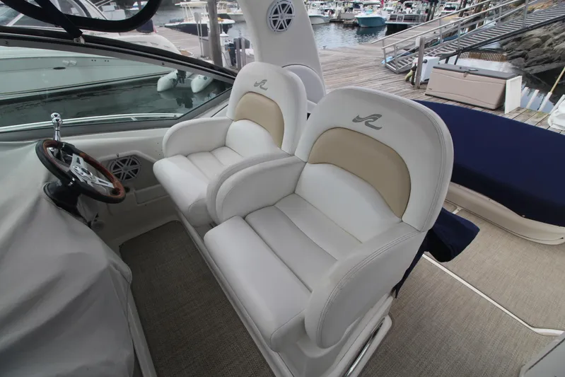  Yacht Photos Pics 2008 Sea Ray 340 Sundancer helm with dual white leather seats at marina.
