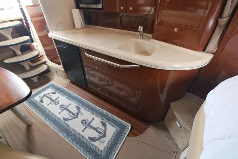  Yacht Photos Pics 2008 Sea Ray 340 Sundancer interior with kitchenette, sink, and nautical-themed rug.
