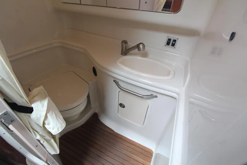  Yacht Photos Pics 2008 Sea Ray 340 Sundancer bathroom with toilet, sink, and wooden floor.
