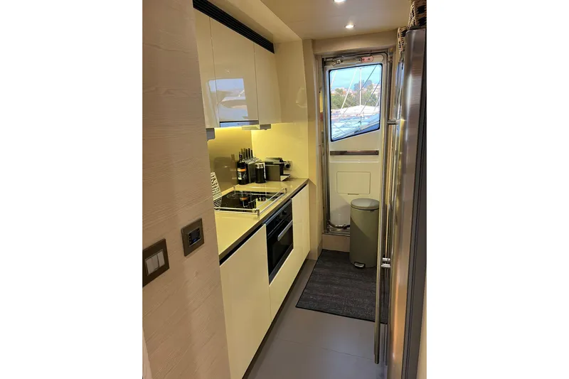 Yacht Photos Pics Modern kitchen interior on 2015 Azimut 80 yacht, featuring sleek cabinetry and appliances.