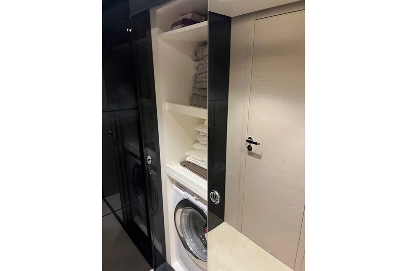  Yacht Photos Pics Laundry area with washer and shelves in 2015 Azimut 80 yacht.