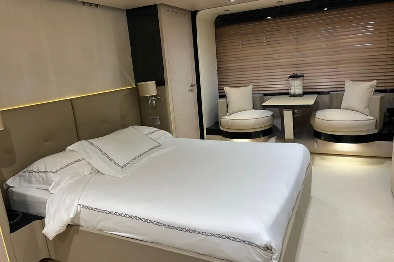  Yacht Photos Pics Luxurious bedroom interior on a 2015 Azimut 80 yacht, featuring elegant furnishings and ambient lighting.
