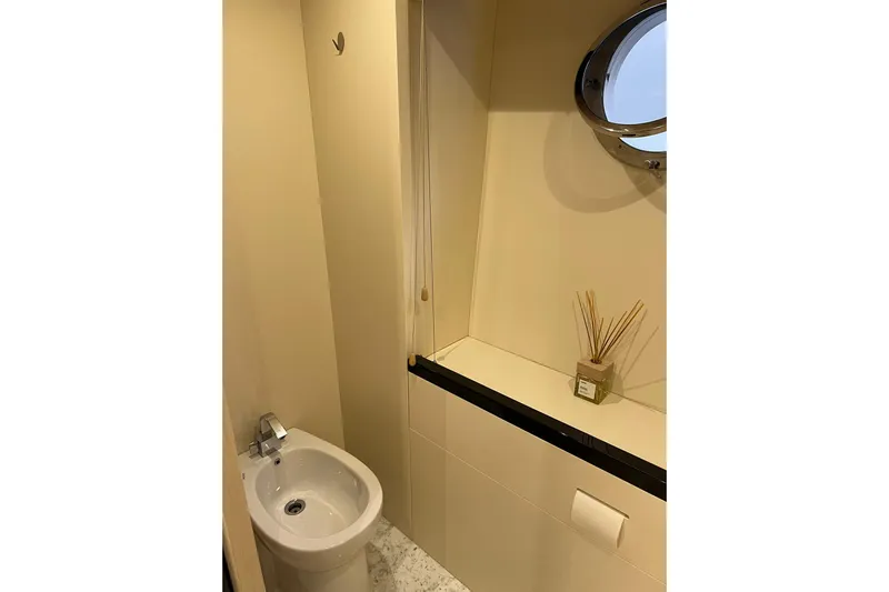  Yacht Photos Pics Bathroom interior of 2015 Azimut 80 yacht with porthole and modern fixtures.