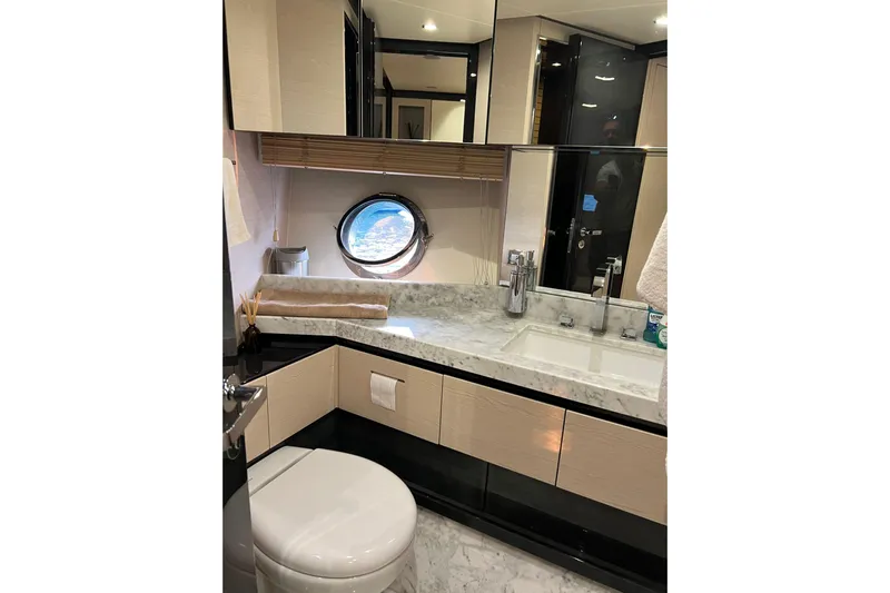  Yacht Photos Pics Luxurious bathroom in 2015 Azimut 80 yacht with marble countertop and ocean view porthole.