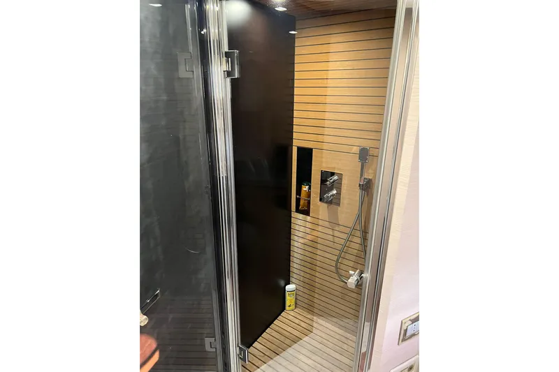  Yacht Photos Pics Luxurious shower in 2015 Azimut 80 yacht with modern fixtures and wooden accents.