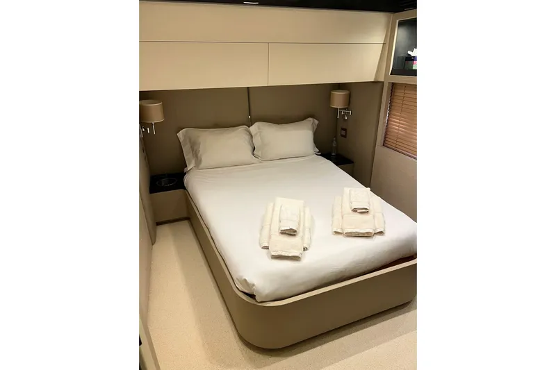  Yacht Photos Pics Luxurious bedroom interior on a 2015 Azimut 80 yacht, featuring a neatly made bed.