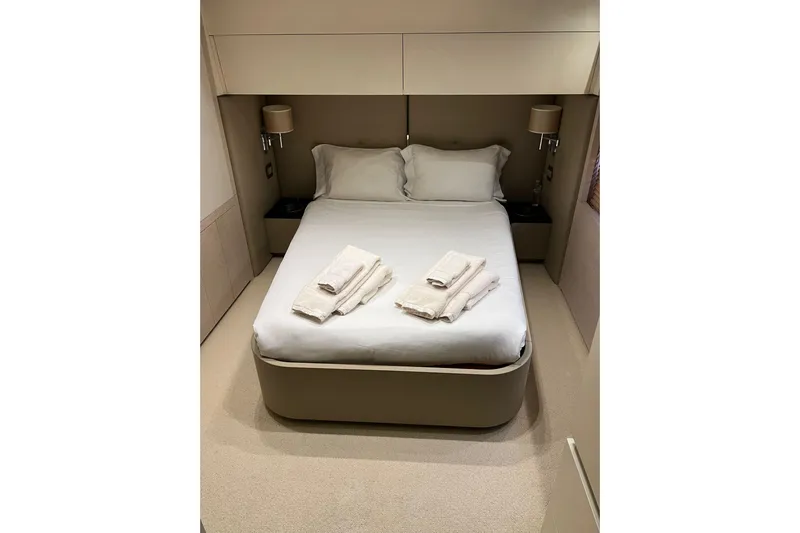 Yacht Photos Pics Luxurious bedroom interior of 2015 Azimut 80 yacht with neatly arranged bed and towels.