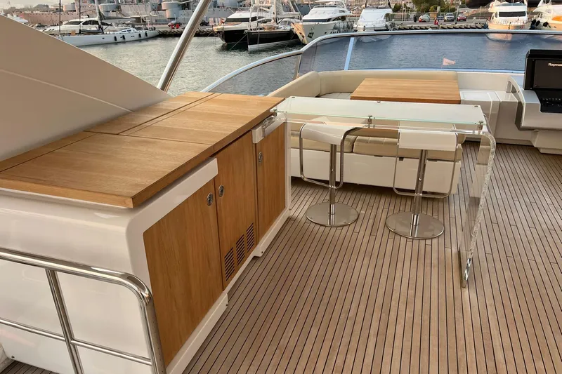  Yacht Photos Pics Luxurious 2015 Azimut 80 yacht deck with seating, bar stools, and wooden cabinetry.