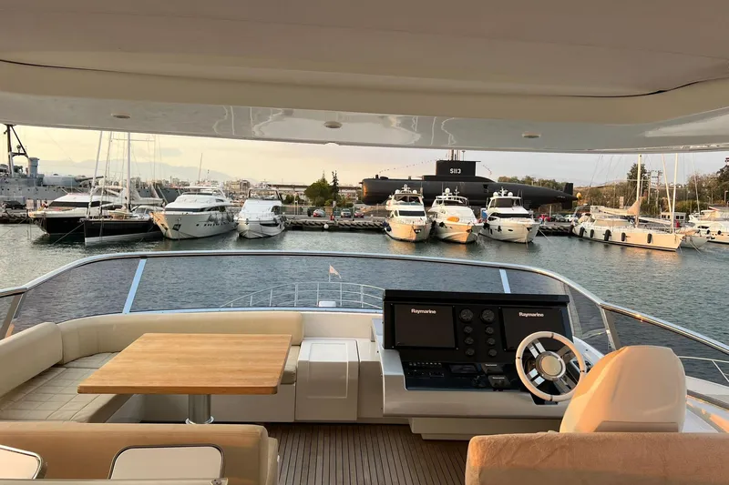  Yacht Photos Pics Luxurious 2015 Azimut 80 yacht interior with marina view, featuring elegant seating and navigation controls.