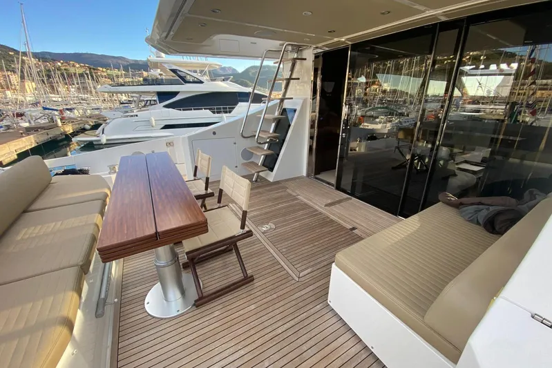  Yacht Photos Pics Luxurious 2016 Azimut 77S yacht deck with elegant seating and wooden table.