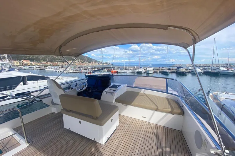  Yacht Photos Pics Flybridge of 2016 Azimut 77S yacht docked at a marina, featuring helm and seating area.