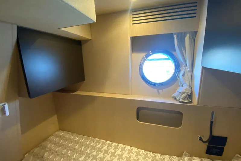  Yacht Photos Pics Cabin interior of 2016 Azimut 77S yacht with porthole and bed.