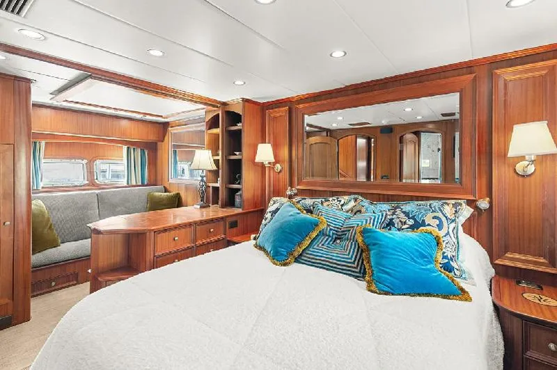 Seas To See Yacht Photos Pics Luxurious 2006 Paragon Cockpit Motoryacht bedroom with elegant wood paneling and plush bedding.