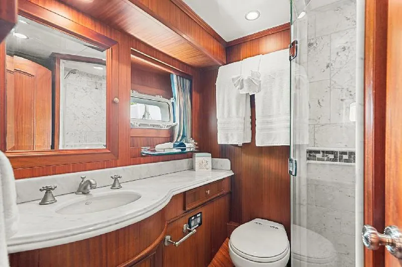 Seas To See Yacht Photos Pics Luxurious bathroom in 2006 Paragon Cockpit Motoryacht with wood accents and marble shower.