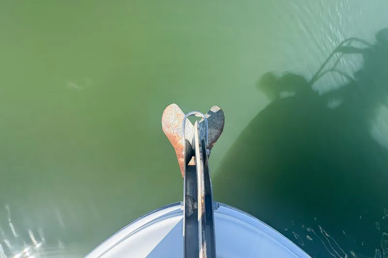 Luna Yacht Photos Pics Bow view of 2008 Sea Ray 380 Sundancer with anchor over green water.