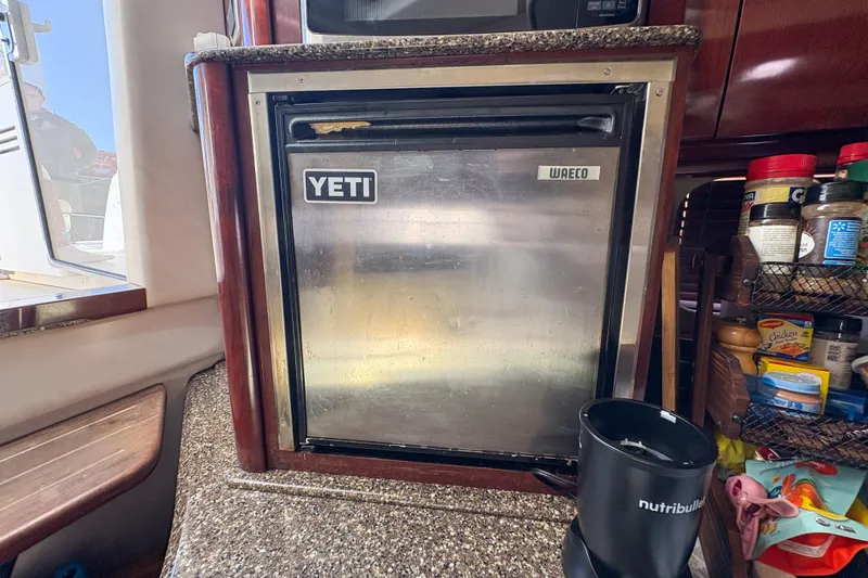 Luna Yacht Photos Pics Compact kitchen area on a 2008 Sea Ray 380 Sundancer yacht with Yeti fridge.