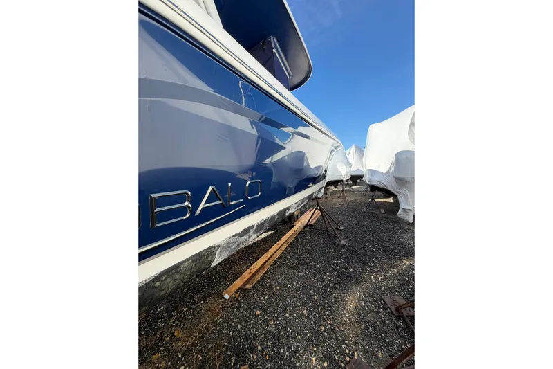 Robalo 272 Yacht Photos Pics 2022 Robalo R272 Center Console boat in storage, blue hull, outdoor setting.